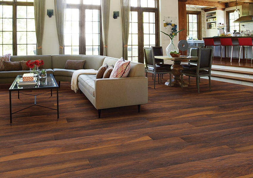 A beautiful cinnamon hickory laminate floor in a large living room