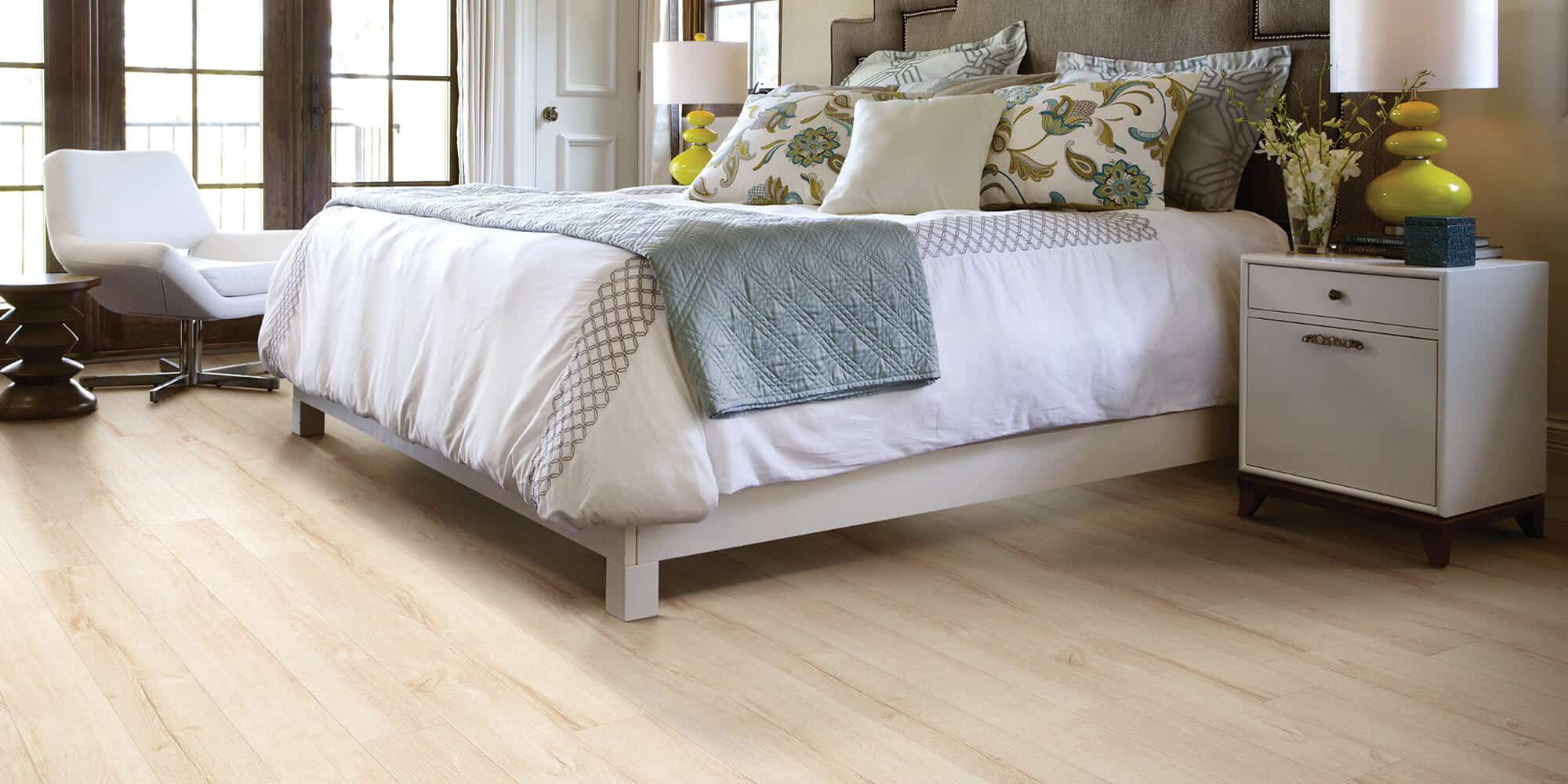 A large queen sized bed on boulevard flooring