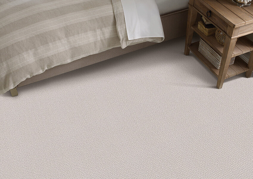 A bedroom with light-colored carpet remnants make a perfect display