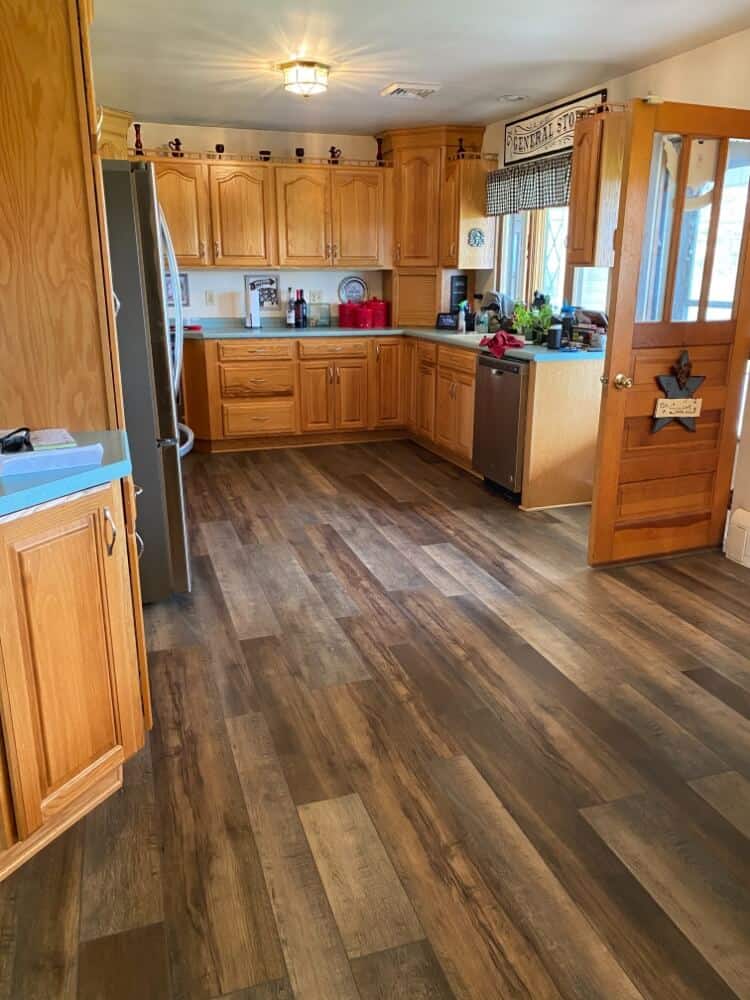 Beautiful multi-colored flooring in a kitchen with an open door