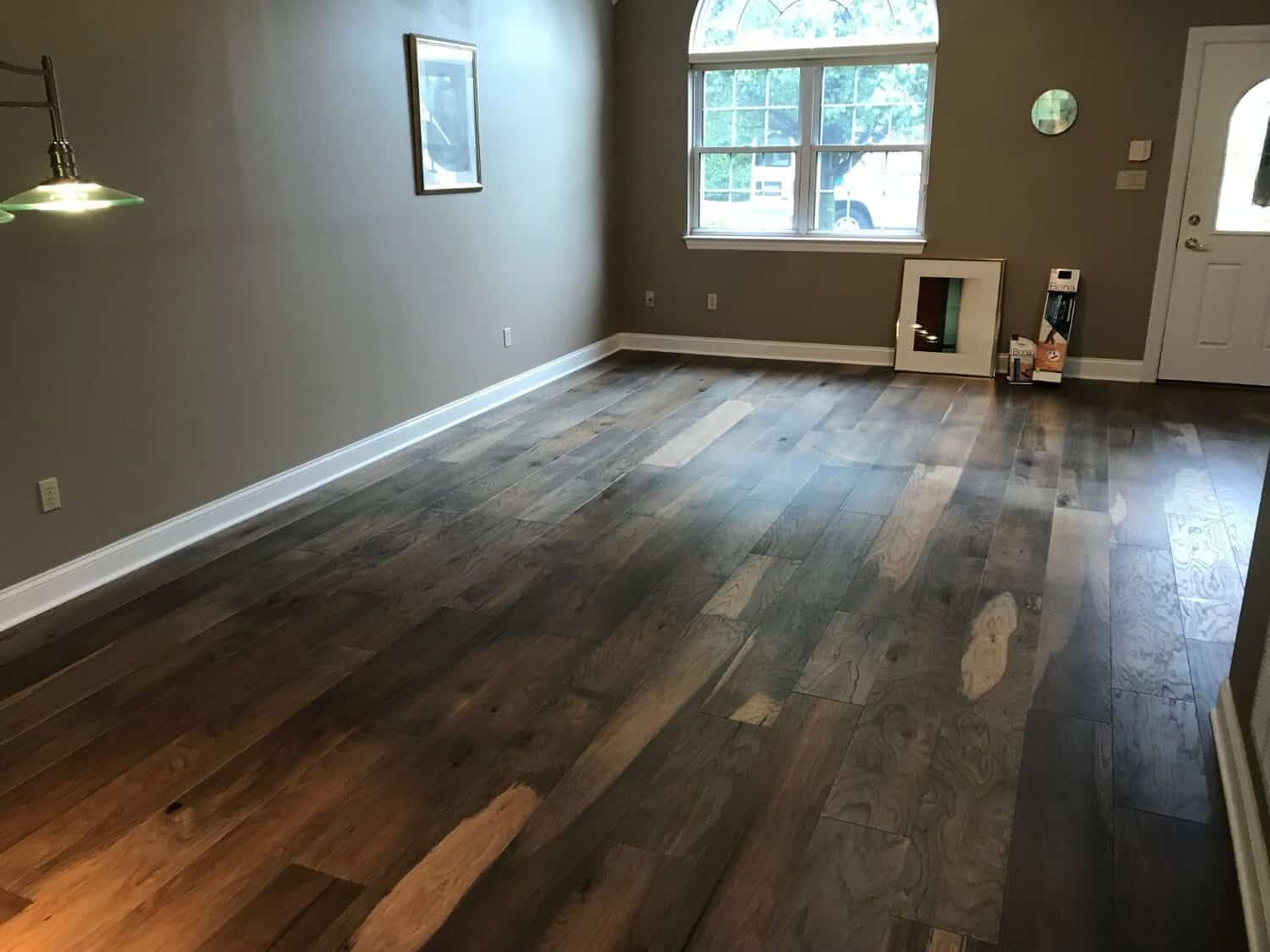Dark brown and caramel colored flooring in a large empty room