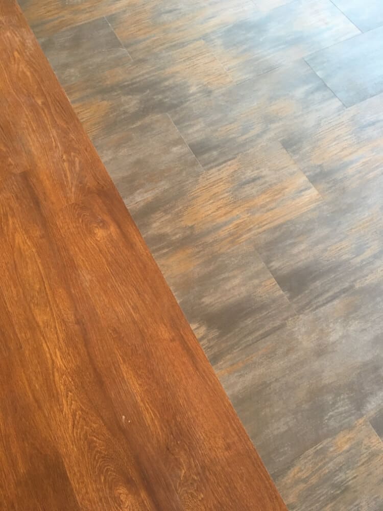 Two different types of flooring pressed against each other